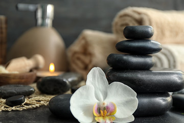 Fototapeta na wymiar Beautiful spa composition with stones and orchid flower on table