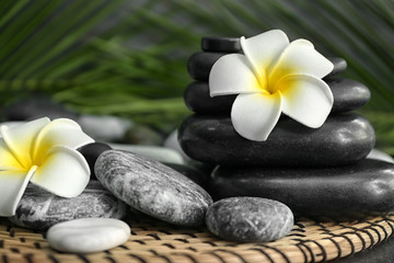 Spa stones and beautiful flowers on table