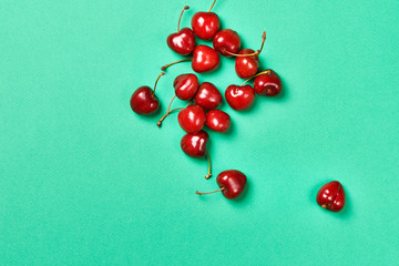Bowl fresh red cherries on green