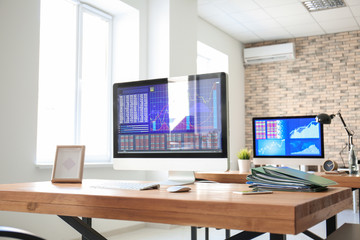 Workplace with computer and folders on table in modern office