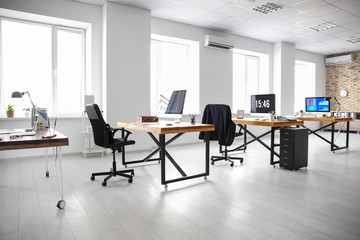 Office interior with tables and armchairs. Workplace design