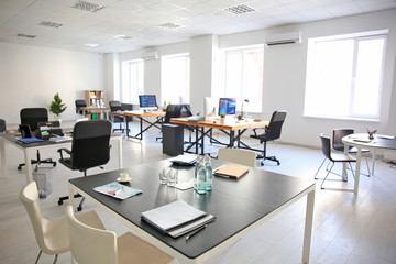 Office interior with tables and chairs. Workplace design