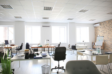 Office interior with tables and armchairs. Workplace design