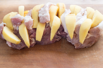 Raw pork neck steak stuffed with pumpkin on wood table