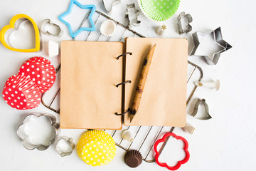 Vintage notebook for ingredients, recipe and note with various baking tools