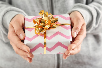 Woman holding gift box, closeup