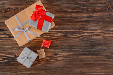 Different gift boxes on wooden background, top view