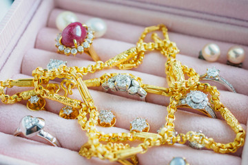 Gold and silver diamond gemstone sapphire ring necklaces and pearl earrings in luxury jewelry box