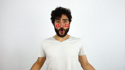 Sport fan celebrating a goal of his team. Man with the flag of Tunisia makeup on his face and white...