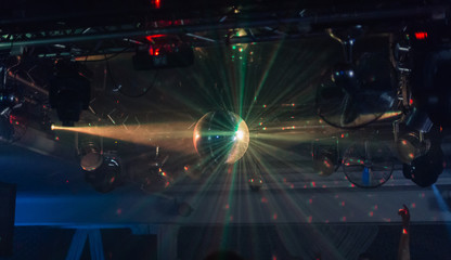 Fototapeta premium Mirror ball in a nightclub with different lights.