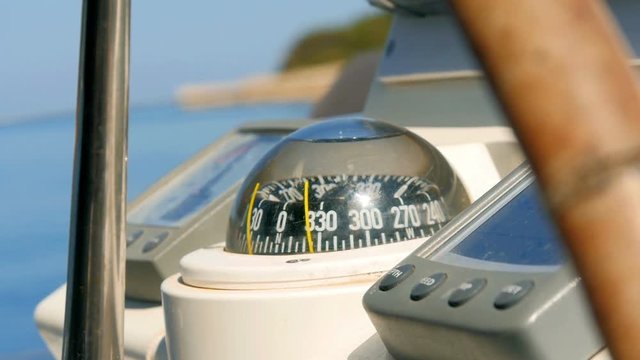 Closeup on navigating instruments behind steering wheel of sailing boat. Filmed on sailing trip in Croatia in slow motion hd.