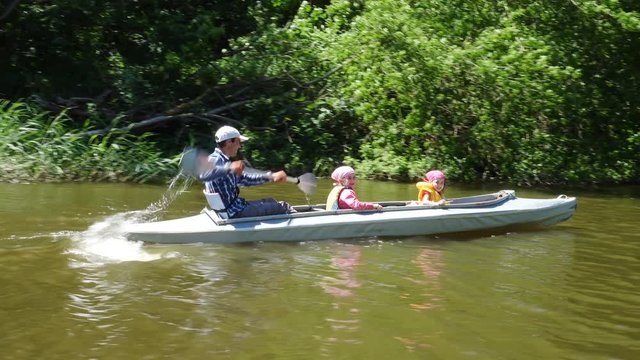 Father and two children kayaking