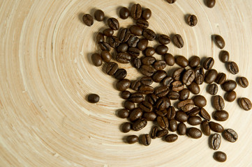 coffee beans scattered on a bamboo board