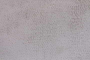 Gray background of concrete with pits and indentations.