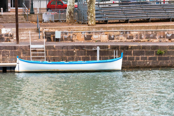 Fototapeta na wymiar View of the white boat on the river Herault, Agde, France. Copy space for text.
