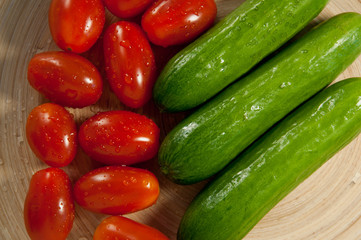 tomatoes and cucumbers on the board