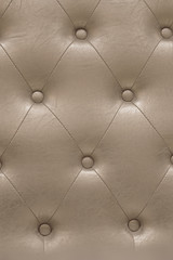 A padded leather cloth in a delicate shade of beige captivating with its meticulously crafted intricate texture carefully designed with quilting pattern which adds a touch of luxury and refinement.