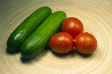 tomatoes and cucumbers on the board