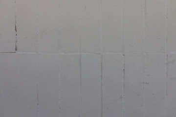 Gray background of concrete with pits and indentations.