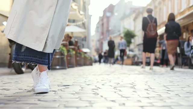 Close Up View Of Freestyle Street Female Dancer Legs Moving On The Street Woman Feet Dancing Slow Motion Spring Fashionable Casual Clothes White Shoes Unrecognisable Girl Walking Crowd On Background