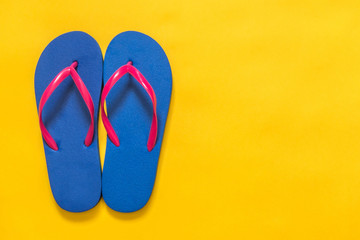 Travel vacation background. Flip flops on a yellow background. Flat lay
