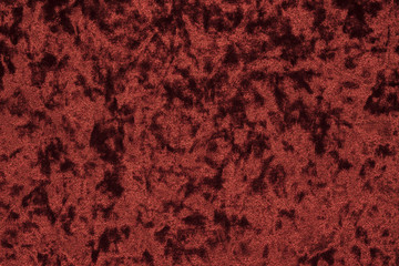 Highly detailed texture background of a red or wine color velour cloth characterized by its lush,...