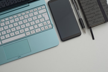 the computer on a desktop with the notebook and the handle