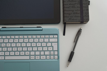 the computer on a desktop with the notebook and the handle