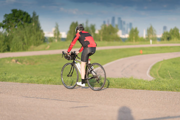 Naklejka premium A cyclist in helmet riding a bike on a special asphalt velo road