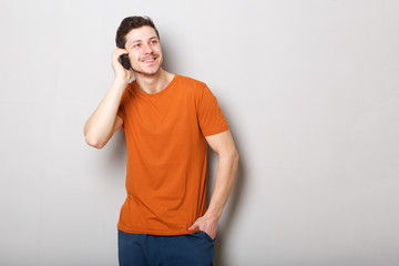 smiling young man talking on cellphone