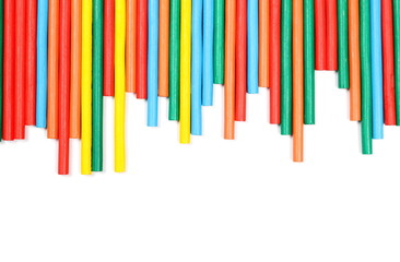Colorful decorative sticks isolated on white background, top view
