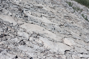 Sun dried earth. Photo background and texture of production of illegal waste in soil. Concept of...