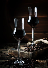 Coffee liqueur, vintage wooden background, selective focus