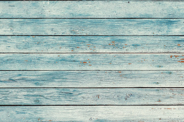 Old blue shabby wooden planks with cracked color paint