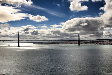 25th April Bridge in Lisbon under cloudy sky