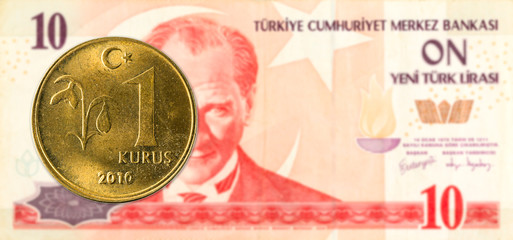 1 turkish kurus coin against 10 turkish lira banknote