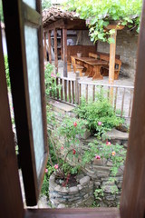 Fototapeta na wymiar View through the window on the beautiful balcony and garden