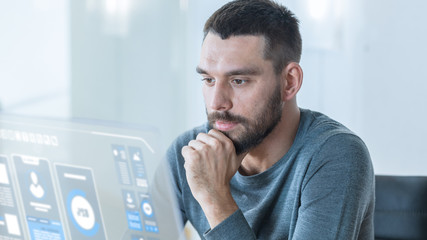 Close up Shot of a Stylish Man Using in His High-Tech Computer with Transparent In the Near Future. He Works in the Ultramodern Light Office.