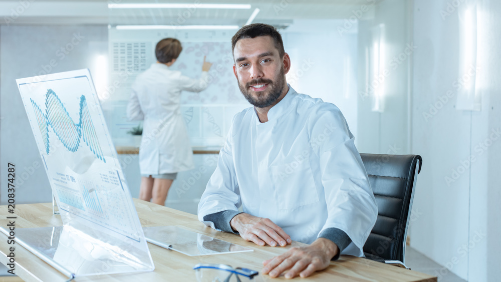Poster in the futuristic laboratory male scientists smiling into camera. he is working with dna structure s