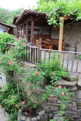 Fototapeta na wymiar Beautiful balcony in the garden covered with liana