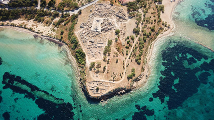 Aerial drone bird's eye view of iconic temple of Apollo on top of Kolona hill with only one pillar...