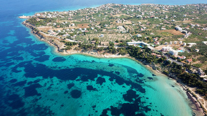 Aerial drone bird's eye view of iconic temple of Apollo on top of Kolona hill with only one pillar left standing, Aigina island, Saronic gulf, Greece