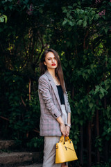 The charming girl stands in the park