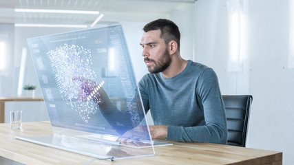 In the Futuristic Laboratory Creative Engineer Works on the Transparent Computer Display. Screen Shows Interactive User Interface with Neural Network, Artificial Intelligence Prototype.