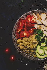 Healthy food, avocado, quinoa, chicken and tomatoes on plate, top view