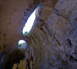 Panorama of the cave with holes in the form of eyes 3