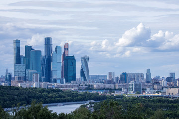 Fototapeta na wymiar The panorama of Moscow, Russia wth Moskva city skyscrapers. The view from the observation platform of Sparrow Hills in the cloudy summer day