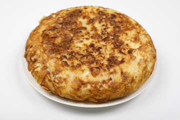 Omelette with potatoes on white background, isolated. Typical spanish food.
