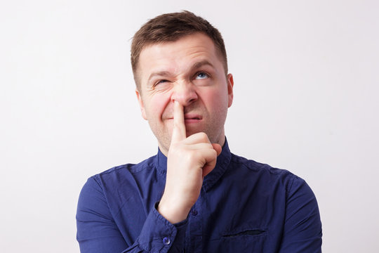 studio portrait caucasian man finger in nose