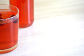 Cranberry or berry juice on wooden background. Copy space for text